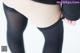 A close up of a person wearing black tights and stockings.