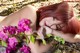 A woman laying on the ground next to a bunch of flowers.