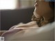 A close up of a woman laying on a bed.