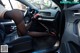 A woman sitting in the driver's seat of a car.